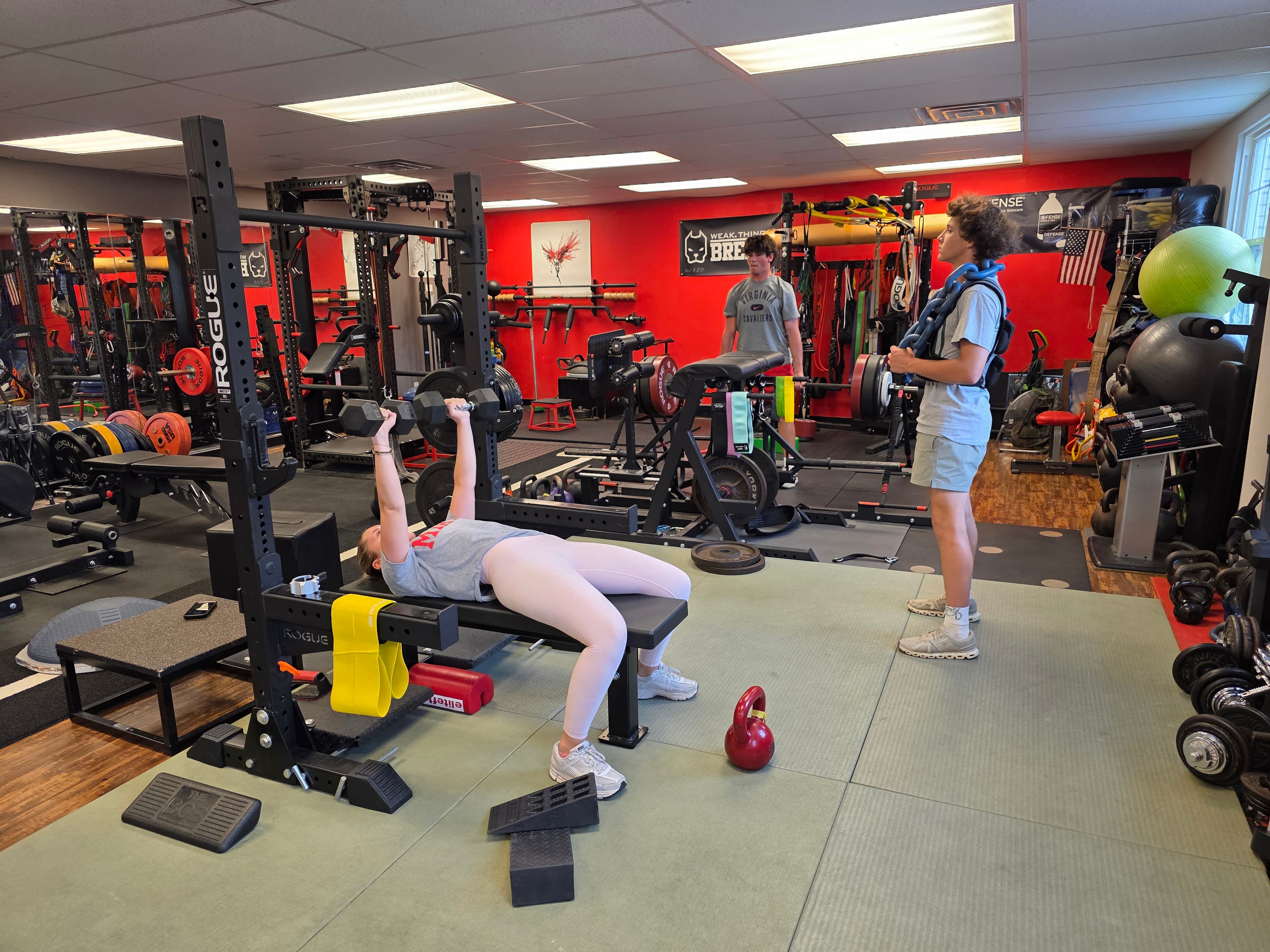 Athlete bench pressing with a spotter at VVV Athletics